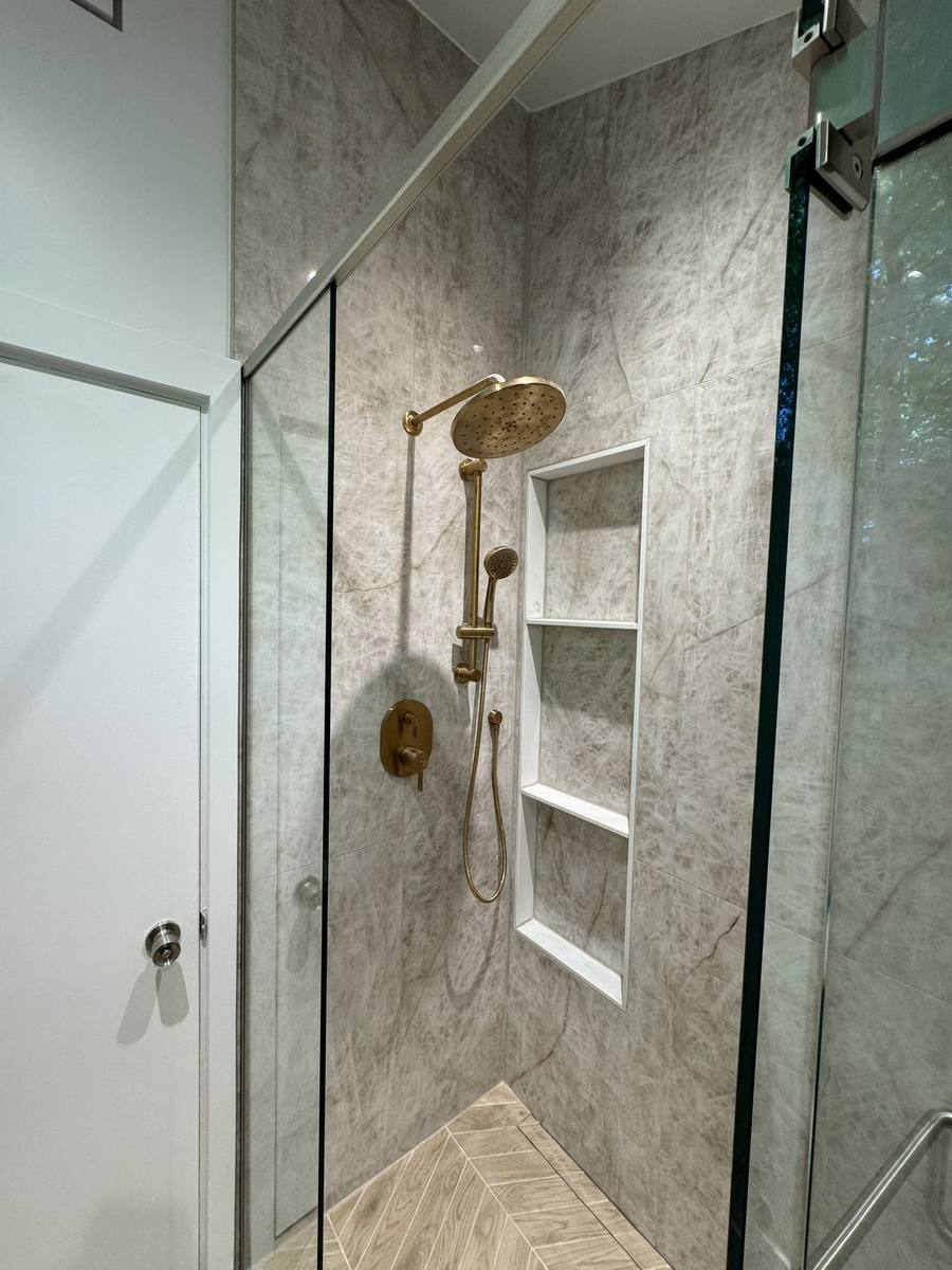 Curbless walk-in shower with brushed brass fixtures and a custom niche, Rothwell Heights